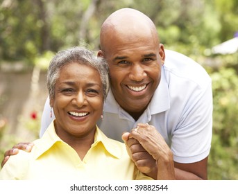 Senior Woman Being Hugged By Adult Son