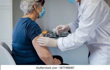 Senior woman being vaccinated against coronavirus by a female doctor - Powered by Shutterstock