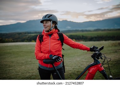 Senior Woman Biker Standing With Bike Outdoors In Nature In Autumn Day.