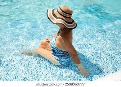 Senior woman in bikini swimsuit and straw hat in blue water pool. Healthy lifestyle in retirement. Back view - Powered by Shutterstock