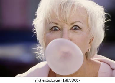 Senior Woman Blowing Bubble Gum