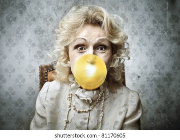 Senior Woman Blowing A Bubblegum