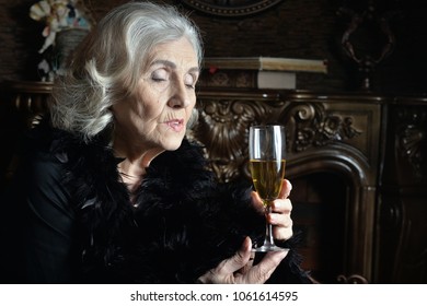 Senior  Woman In Boa  Posing At Home