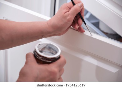 Senior Woman With A Brush Repairs A Damaged Cabinet Door, Painting Old Furniture