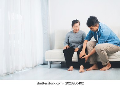 Senior woman and care giver in living room, senior woman pain from knee