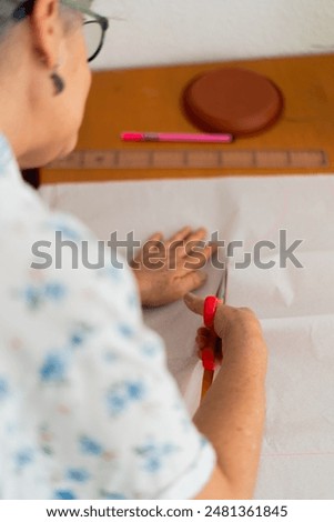 Similar – Image, Stock Photo Woman carefully cutting paper design in studio