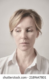 Senior Woman In Casuals Looking Aside Serious. White Background Studio Shot.