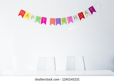 Senior Woman Celebrating Her Birthay At Home With Cake, Ballons And Confetti