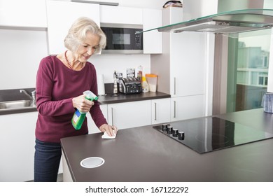 Senior Woman Cleaning Kitchen Counter