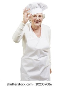 Senior Woman Cook Doing An Excellent Symbol Against A White Background