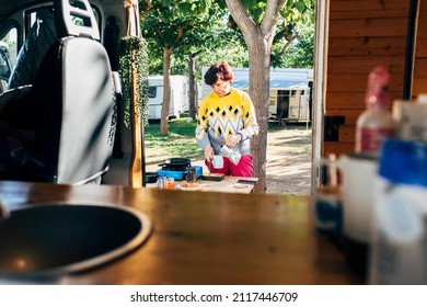 Senior Woman Cooking Breakfast With The Camping Gas Black In The Camping In Camper Van