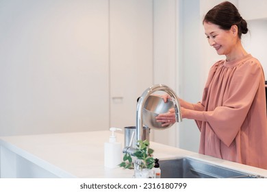 A senior woman cooking in the kitchen - Powered by Shutterstock