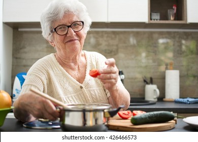 Senior Woman Cooking In The Kitchen.