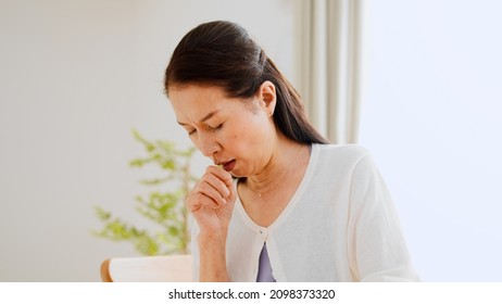 Senior Woman Coughing At Home	