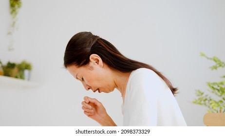 Senior Woman Coughing At Home	