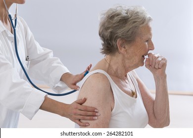 Senior Woman Coughing While Doctor Examining Her