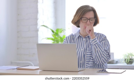 Senior Woman Coughing While Using Laptop