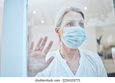 Senior Woman, Covid And Face Mask With Hand On Window For Anxiety, Mental Health And Safety In House During Retirement. Lonely Female At, Home During Covid 19 Lockdown For Government Compliance