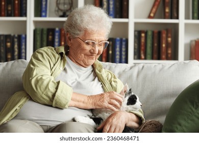 Senior woman with cute cat resting at home - Powered by Shutterstock