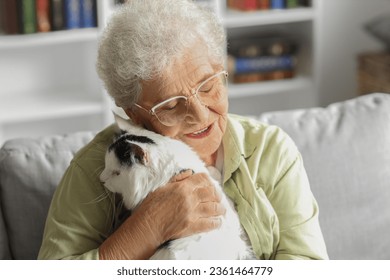 Senior woman with cute cat resting at home - Powered by Shutterstock