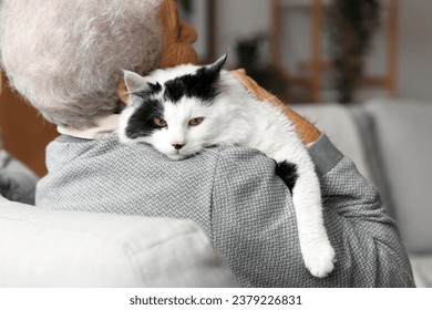 Senior woman with cute cat resting at home - Powered by Shutterstock