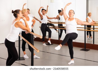 Senior Woman Demonstraiting Ballet Moves During Group Dance Training.