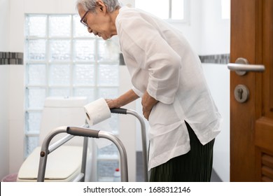 Senior Woman With Diarrhea Holding Tissue Roll Near A Toilet Bowl,elderly Have Abdominal Pain,stomach Ache,constipation In Bathroom,sick People Hand Touch The Belly Diarrhea,irritable Bowel Syndrome