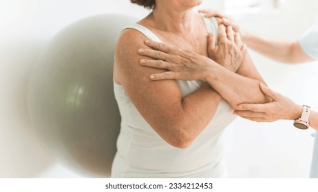 A Senior woman do wall squats with fit ball - Powered by Shutterstock