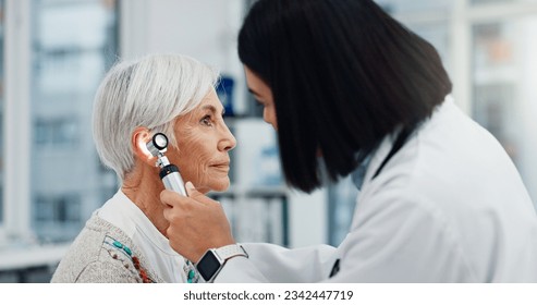 Senior woman, doctor and otoscope for ear, hearing test and exam, audio check or consultation for healthcare. Ent, otolaryngology and medical professional with elderly person for wellness in hospital - Powered by Shutterstock