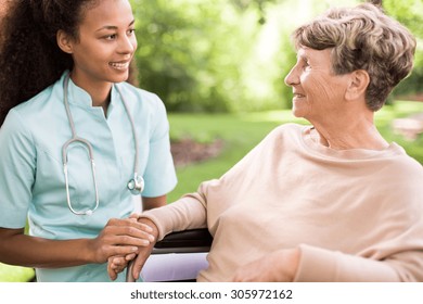 Senior Woman And Doctor Spending Time In The Garden