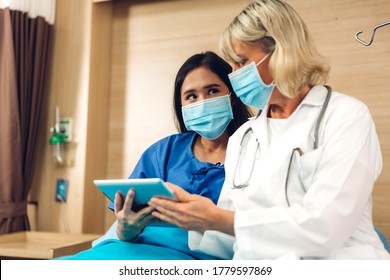 Senior Woman Doctor Wearing Protective Mask With Stethoscope Service Help Support Discussing And Consulting Talk To Sick Woman Patient About Checkup Result Information With Tablet In Hospital