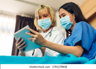 Senior Woman Doctor Wearing Protective Mask With Stethoscope Service Help Support Discussing And Consulting Talk To Sick Woman Patient About Checkup Result Information With Tablet In Hospital