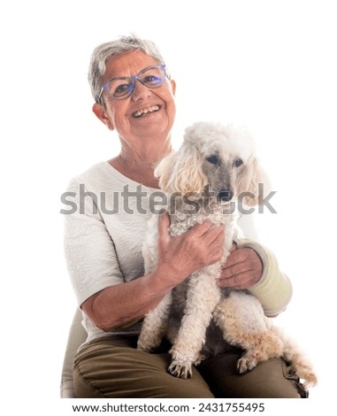 senior woman and dog in front of white background