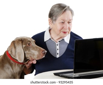 Senior Woman With Dog Working On A Laptop