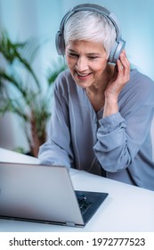 Senior Woman Doing Audiogram Hearing Test At Home, Using Laptop