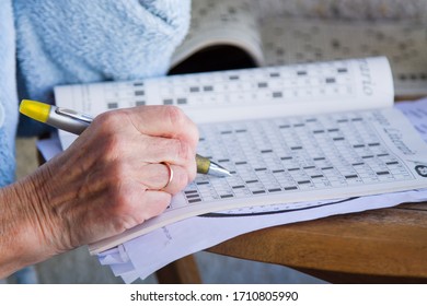 Senior Woman Doing Crossword Puzzles And Hobbies