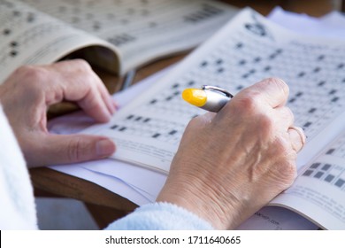 Senior Woman Doing Crossword Puzzles And Hobbies