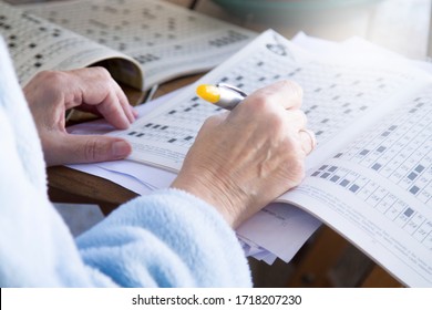 Senior Woman Doing Crossword Puzzles And Hobbies