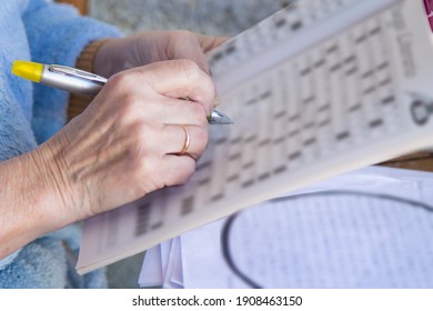 Senior Woman Doing Crossword Puzzles And Hobbies