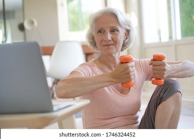 Senior Woman Doing Fitness Exercises With Virtual Class