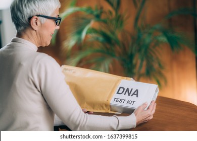 Senior Woman Doing A Mailed DNA Test At Home