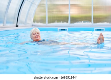 Senior Woman Doing Rehab Backstroke In The Hydrotherapy Pool