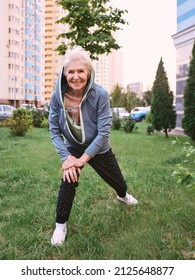 Senior Woman Doing Sport Exercises In The Park. Healthy Lifestyle Concept