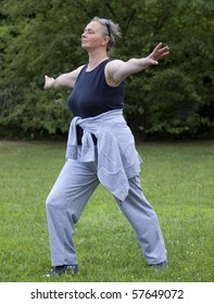 Senior Woman Doing Tai Chi Against Outdoors