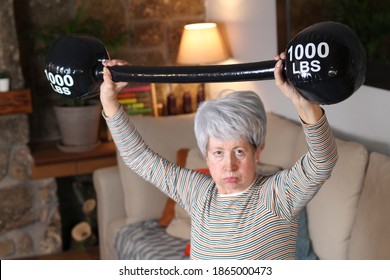 Senior Woman Doing Weight Lifting At Home