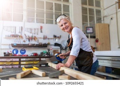 Senior Woman Doing Woodwork In A Workshop