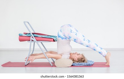 Senior Woman Doing Yoga With Chair At Home. Stretching Exercises