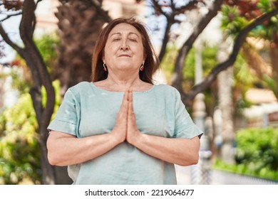 Senior Woman Doing Yoga Exercise At Park