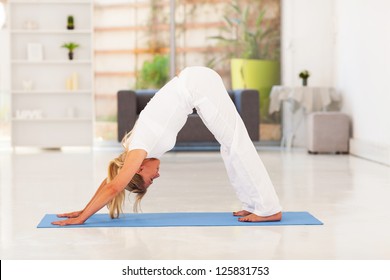 Senior Woman Doing Yoga At Home