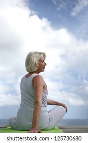 Senior Woman Doing Yoga Outdoors